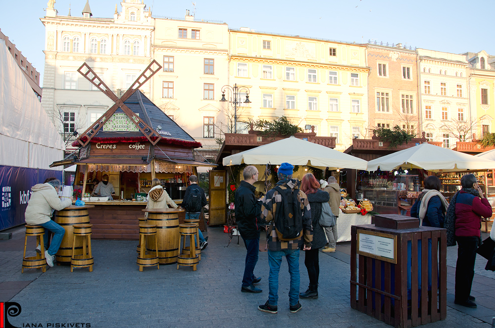 Christmas in Krakow. This year my family was lucky to visit the Catholic Christmas in Krakow. It was abnormally warm winter +14°C. No snow. Christmas fairs, festive streets, countless tourists, this is what Krakow is on holiday. It is hectic and dreamy at the same time. There are many decorated Christmas trees in the main square, as well as other trees dressed with garlands, wooden huts with various tasty foods – from sausages and barbecue to caramelized apples and biscuits – delicacies suiting every taste. Fair is the highlight of Christmas city for tourists. These days the fair is also in Krakow. Here you can try a variety of tasty foods: fried sausages and potatoes, bigos, dumplings, grilled chicken breast, flavored mulled wine...Shooting photos, I was sorry that couldn’t express delicious flavor that was in the air and attracted passersby. There were a lot of Christmas trees and huge bright colored ornaments, near which I felt very tiny. There also were handmade ceramics, various stuffed toys, straw angels and Christmas decorations to fit every taste.