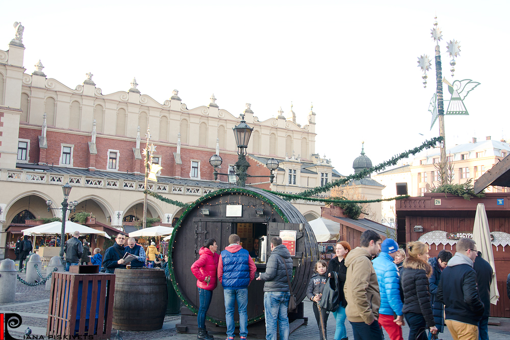 Christmas in Krakow. This year my family was lucky to visit the Catholic Christmas in Krakow. It was abnormally warm winter +14°C. No snow. Christmas fairs, festive streets, countless tourists, this is what Krakow is on holiday. It is hectic and dreamy at the same time. There are many decorated Christmas trees in the main square, as well as other trees dressed with garlands, wooden huts with various tasty foods – from sausages and barbecue to caramelized apples and biscuits – delicacies suiting every taste. Fair is the highlight of Christmas city for tourists. These days the fair is also in Krakow. Here you can try a variety of tasty foods: fried sausages and potatoes, bigos, dumplings, grilled chicken breast, flavored mulled wine...Shooting photos, I was sorry that couldn’t express delicious flavor that was in the air and attracted passersby. There were a lot of Christmas trees and huge bright colored ornaments, near which I felt very tiny. There also were handmade ceramics, various stuffed toys, straw angels and Christmas decorations to fit every taste.