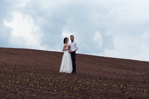 bride and groom in a field